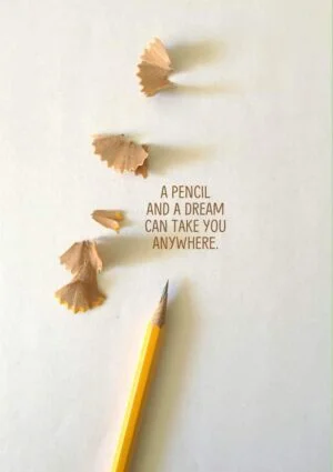 Pencil Dreams - a pencil and shavings that seem to be flying away and text 'A Pencil And A Dream Can Take You Anywhere'