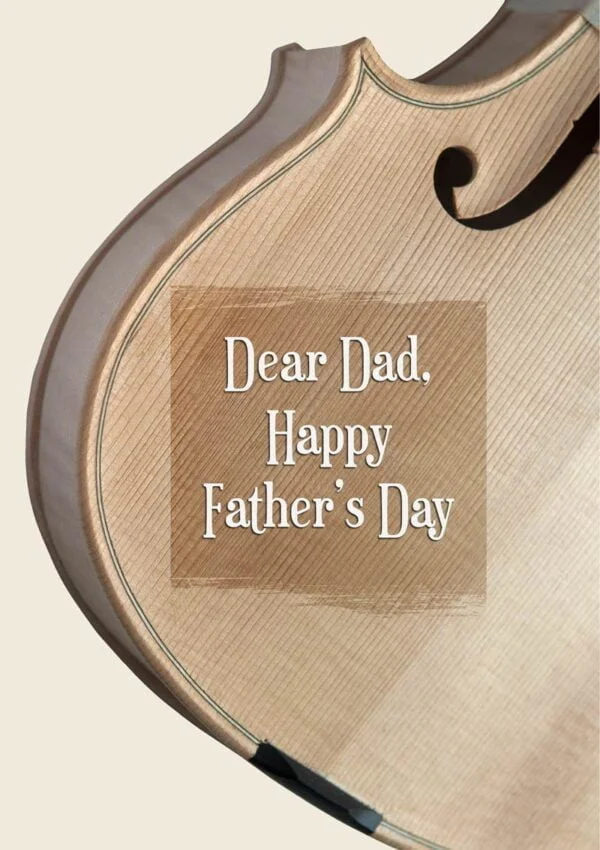 An unvarnished violin body with an overlaid varnished area and text 'Dear Dad - Happy Father's Day'